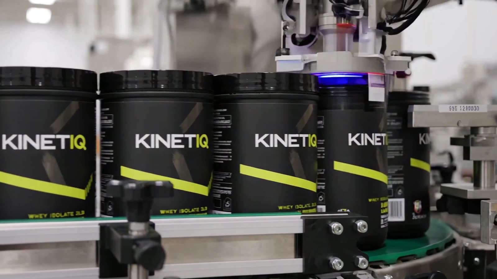 Powder blending, automated filling and protein tubs being sealed, labelled and coded on a supplement production line